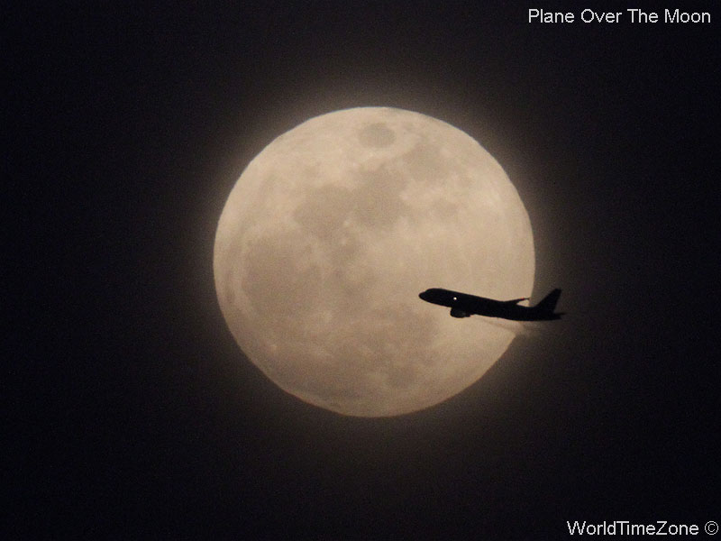 Plane over the Moon by worldtimezone