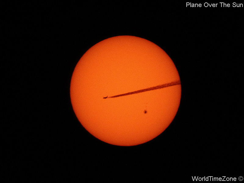 Plane over the Sun by worldtimezone